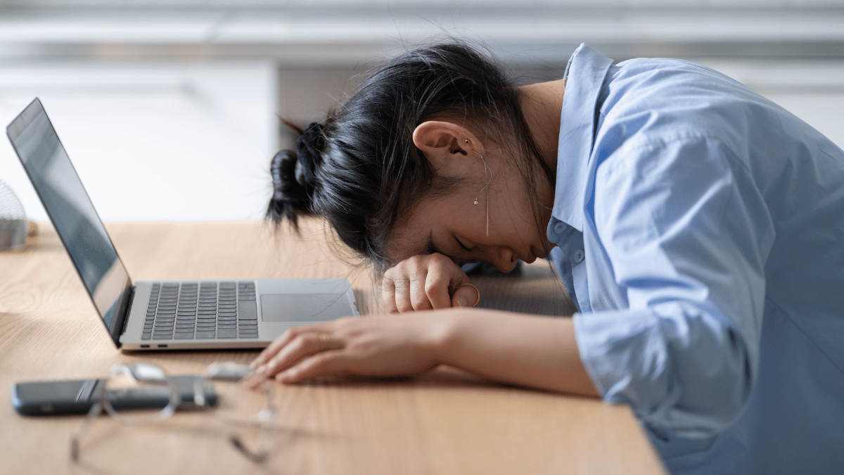 woman burnout from work in front of laptop